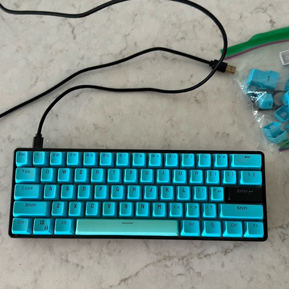 Kraken pro 60 gaming keyboard. Black and light blue keys with cable